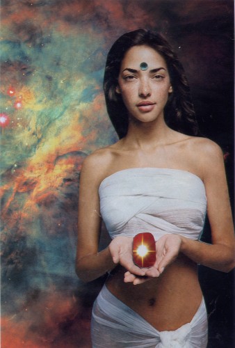 Woman holding a shiny jewel.